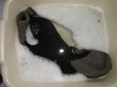 Immersing the socks in hot water and detergent